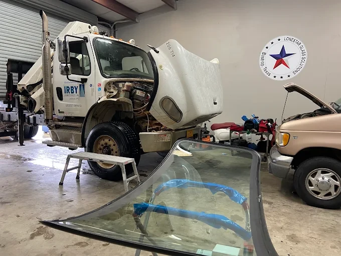 Auto glass technician working on a vehicle windshield